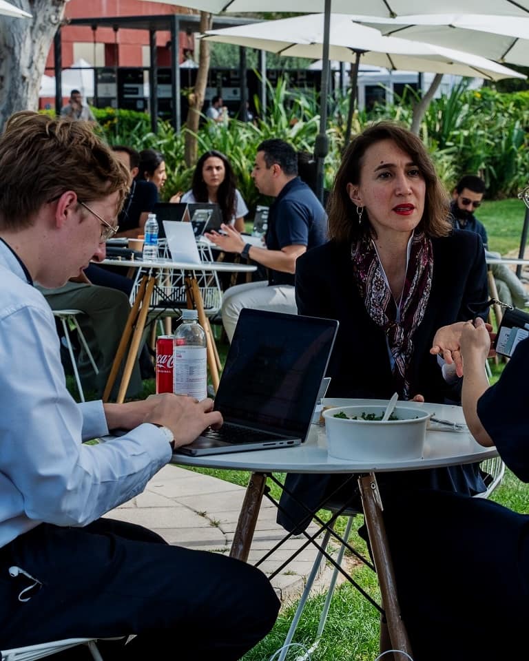 Founders talking at a lakeside table at Step Dubai 2025